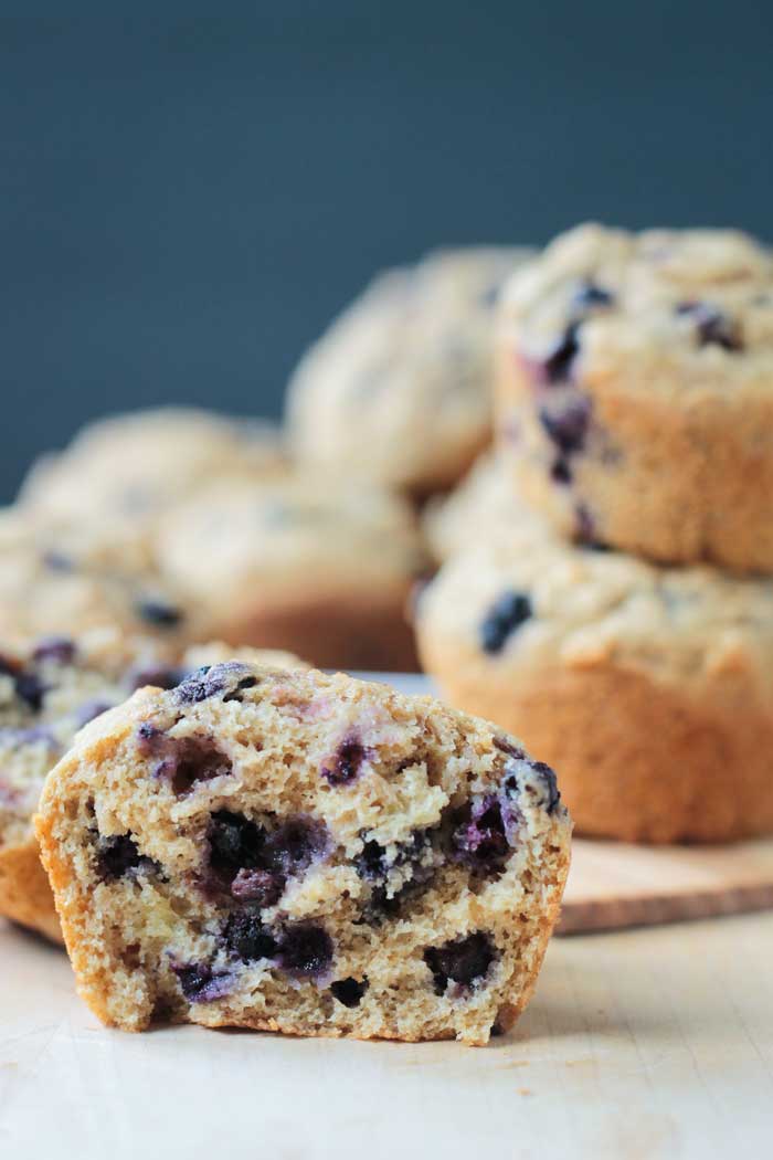 Close up of blueberries inside half of a muffin.
