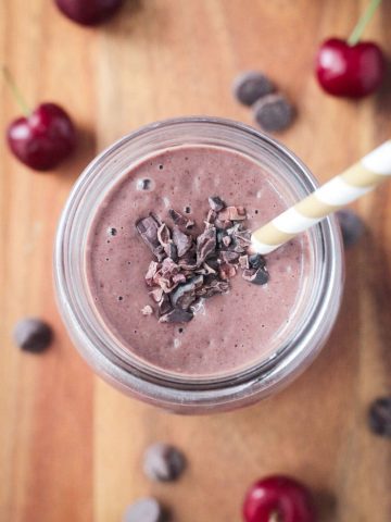 Top of a smoothie garnished with cocoa nibs.