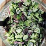 Salad ingredients and dressing all mixed together in a bowl.