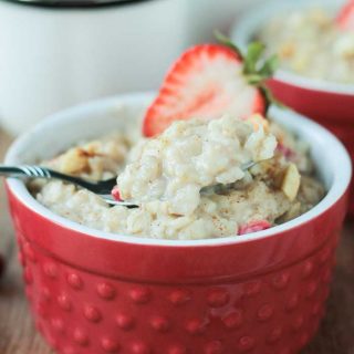 bowl of oatmeal topped with fresh strawberry