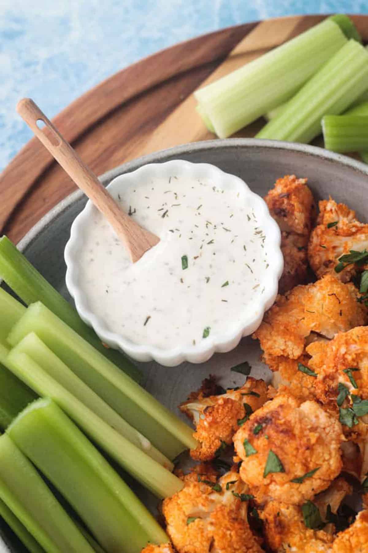 Small white bowl of ranch dressing.