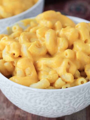 Creamy macaroni and cheese in a white bowl.