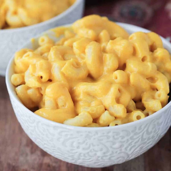 Creamy macaroni and cheese in a white bowl.