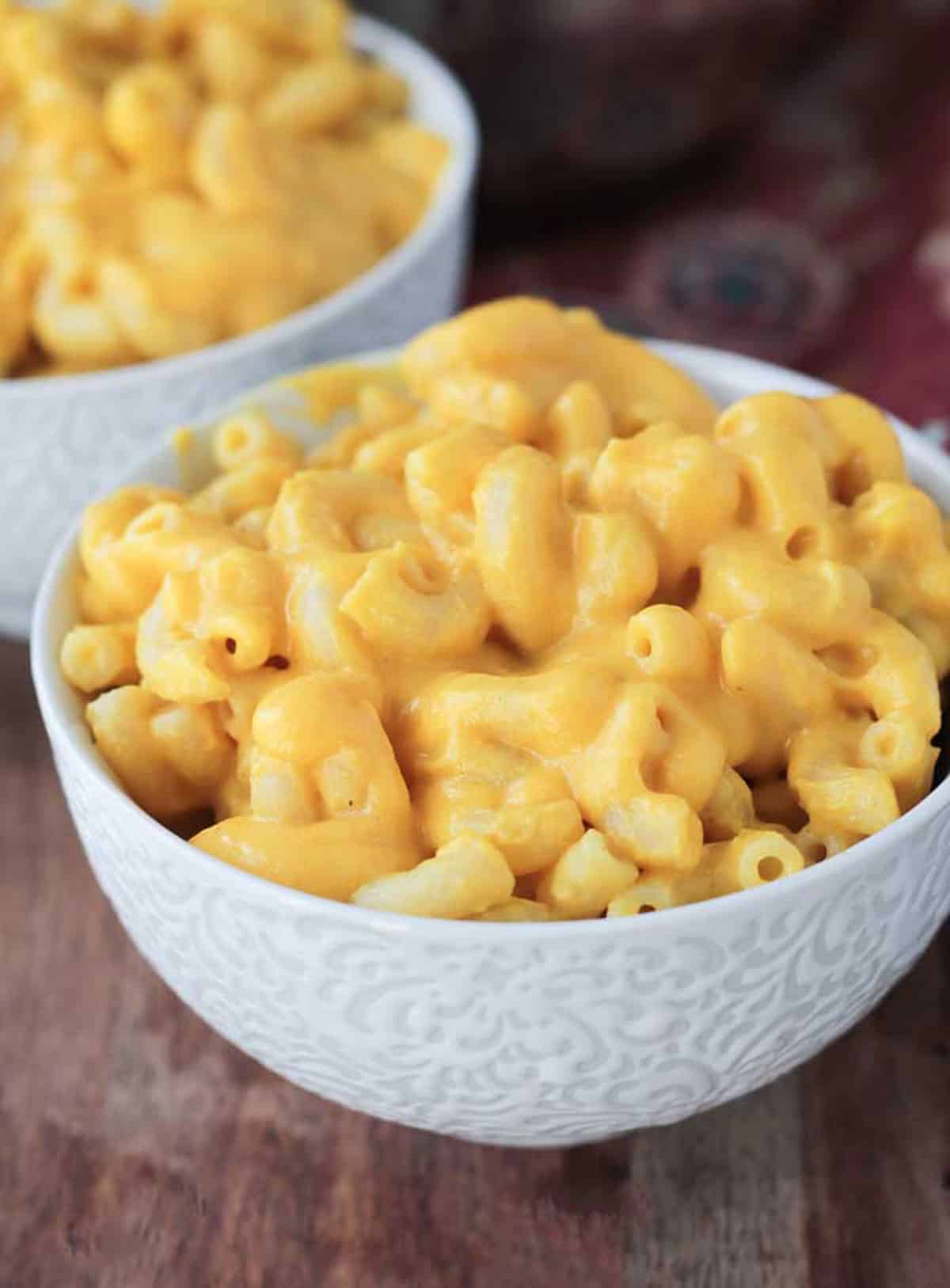 Creamy macaroni and cheese in a white bowl.