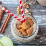 Diced cinnamon apple topping on a creamy apple smoothie.