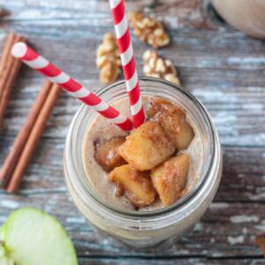 Diced cinnamon apple topping on a creamy apple smoothie.