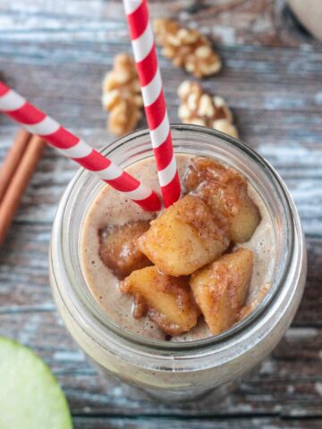 Diced cinnamon apple topping on a creamy apple smoothie.