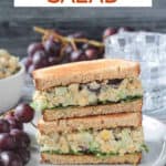 Two halves of a vegan chickpea salad sandwich stacked on each other.