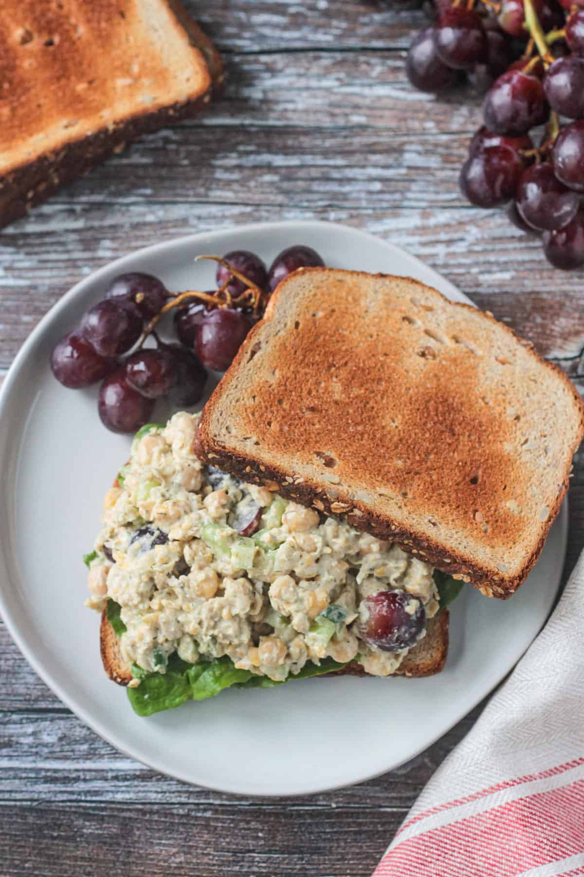 Overhead view of creamy chickpea salad on toast.