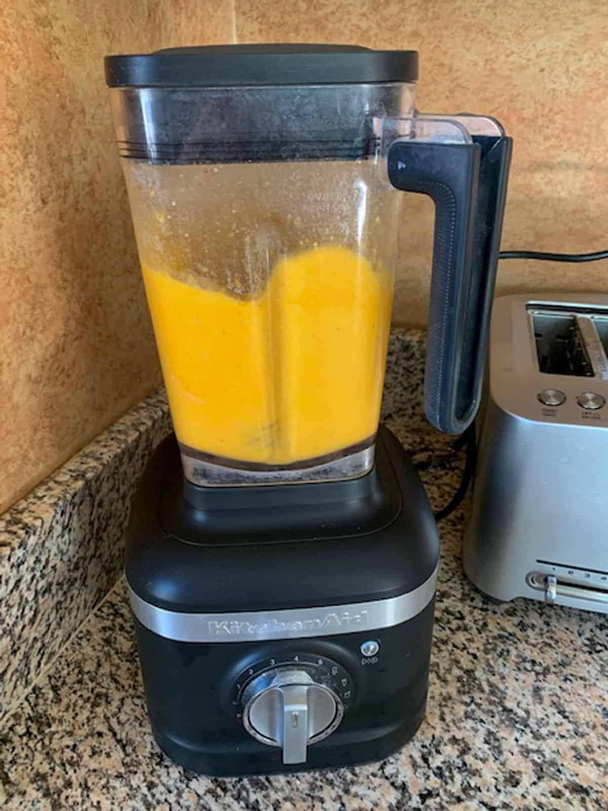 Puréed butternut squash cheese sauce in a blender.