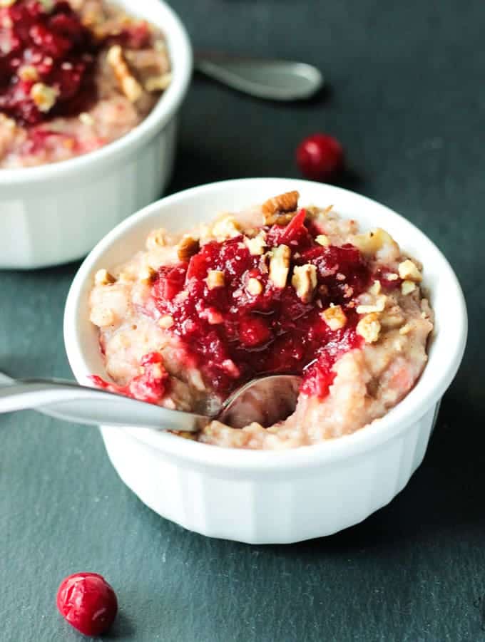 Metal spoon in a bowl of Creamy Cranberry Oatmeal.