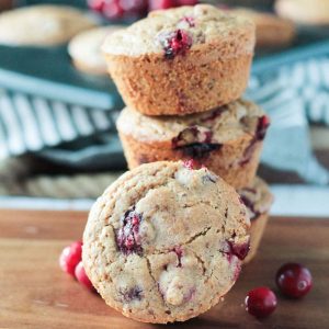 One cranberry almond muffin in front of a stack of 3 more.