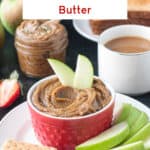 Two apple slices in a bowl of cookie butter next to a cup of coffee and stack of toast.