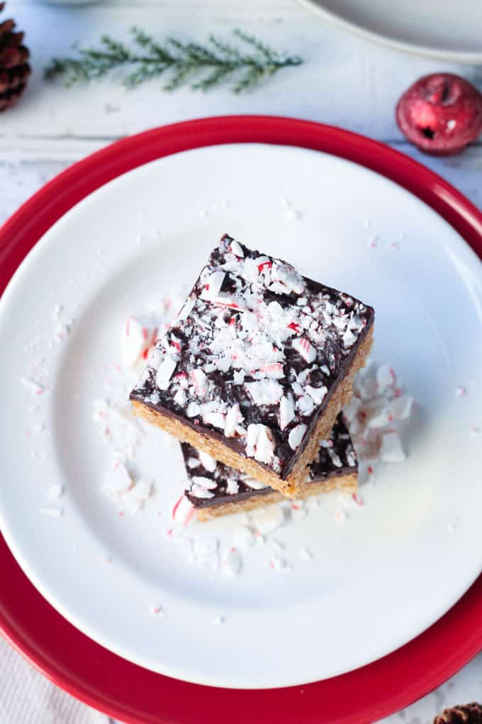 Overhead view of a stack of peppermint cereal bars on a white plate.