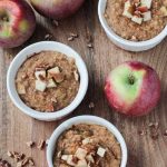 three bowls of oatmeal topped with apples