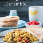 A plate of tofu scramble in front of a plate of stacked toast and a cup of coffee.