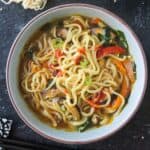 Spicy vegan ramen noodle soup with vegetables in a bowl.