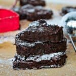 Stack of three sugared black bean brownies.