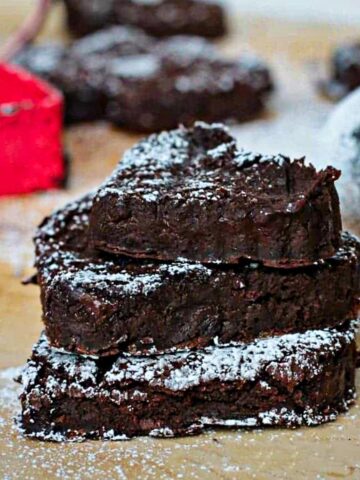 Stack of three sugared black bean brownies.