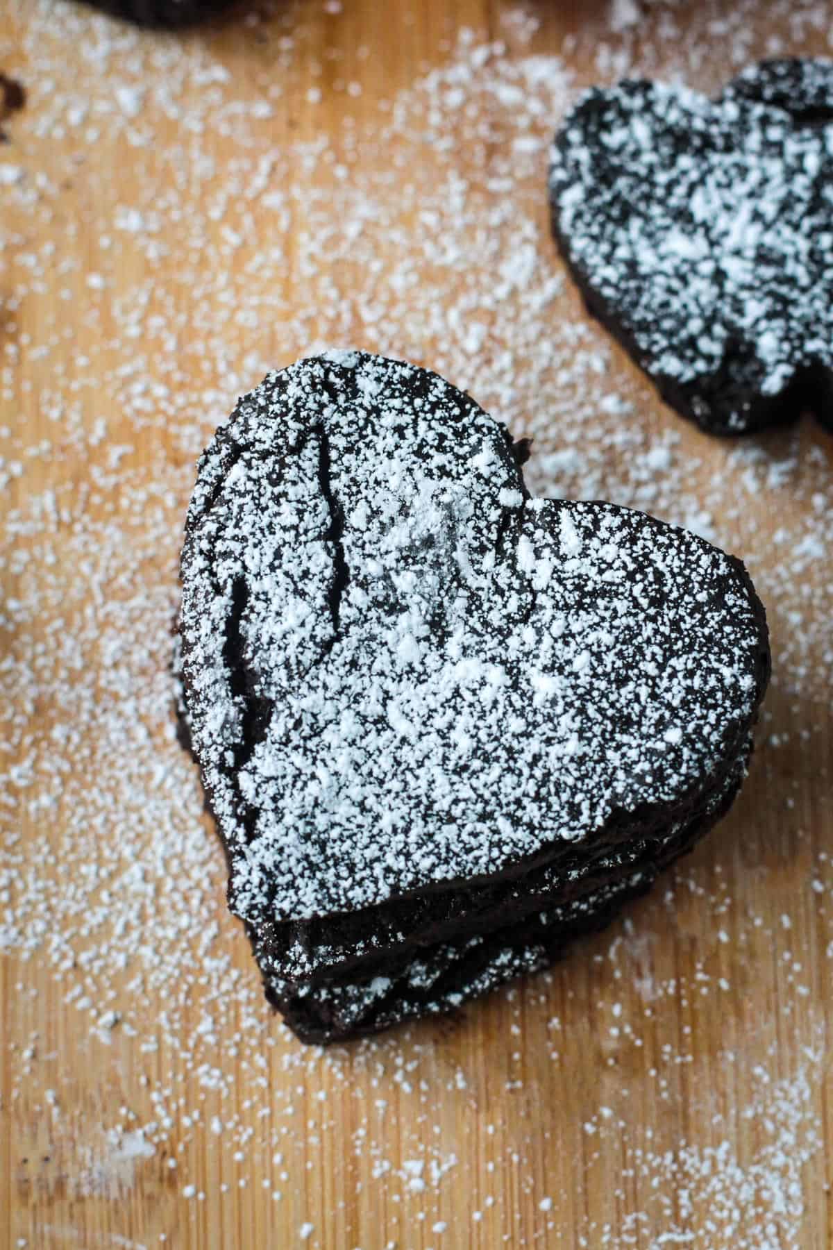 Overhead of a heart shaped black bean brownies dusted in powdered sugar.