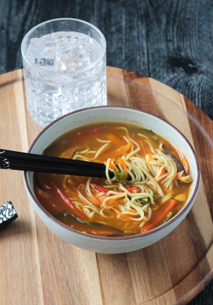 Chopsticks tangled in noodles in the soup