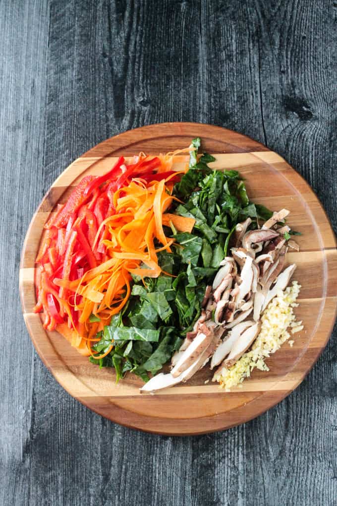 Chopped veggies lined up on a wooden tray