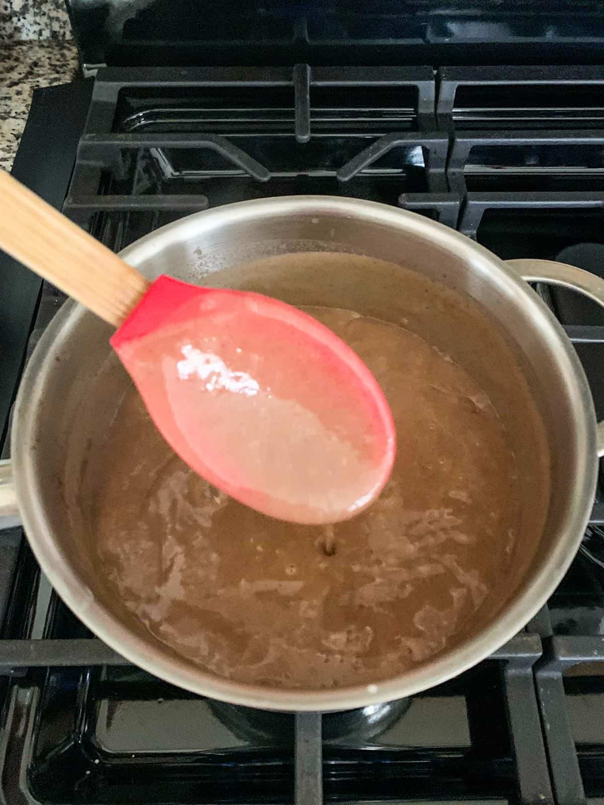 Thick custard coating a spoon.