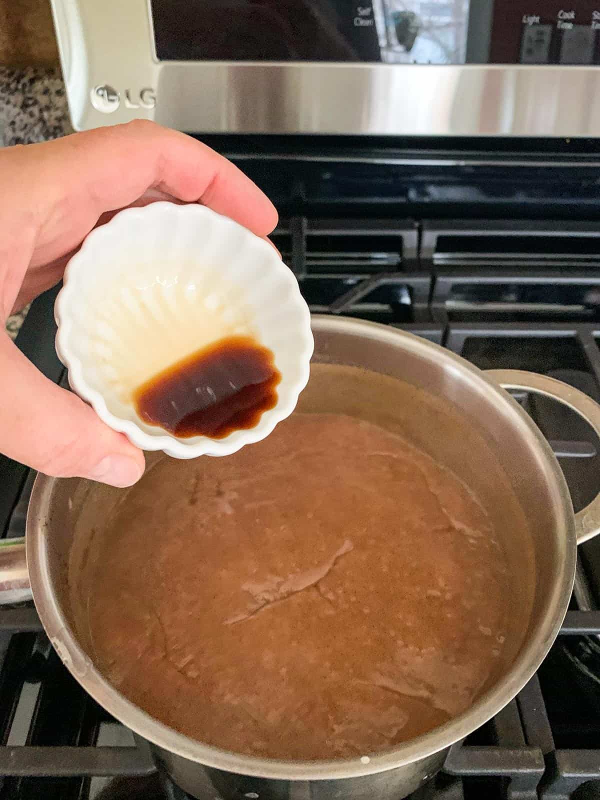 Adding vanilla to the pot.