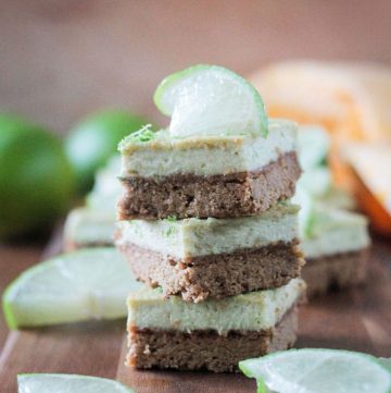 Stack of three vegan lime bars on a wooden tray.