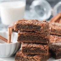 Stack of 4 cinnamon blondies on a plate.