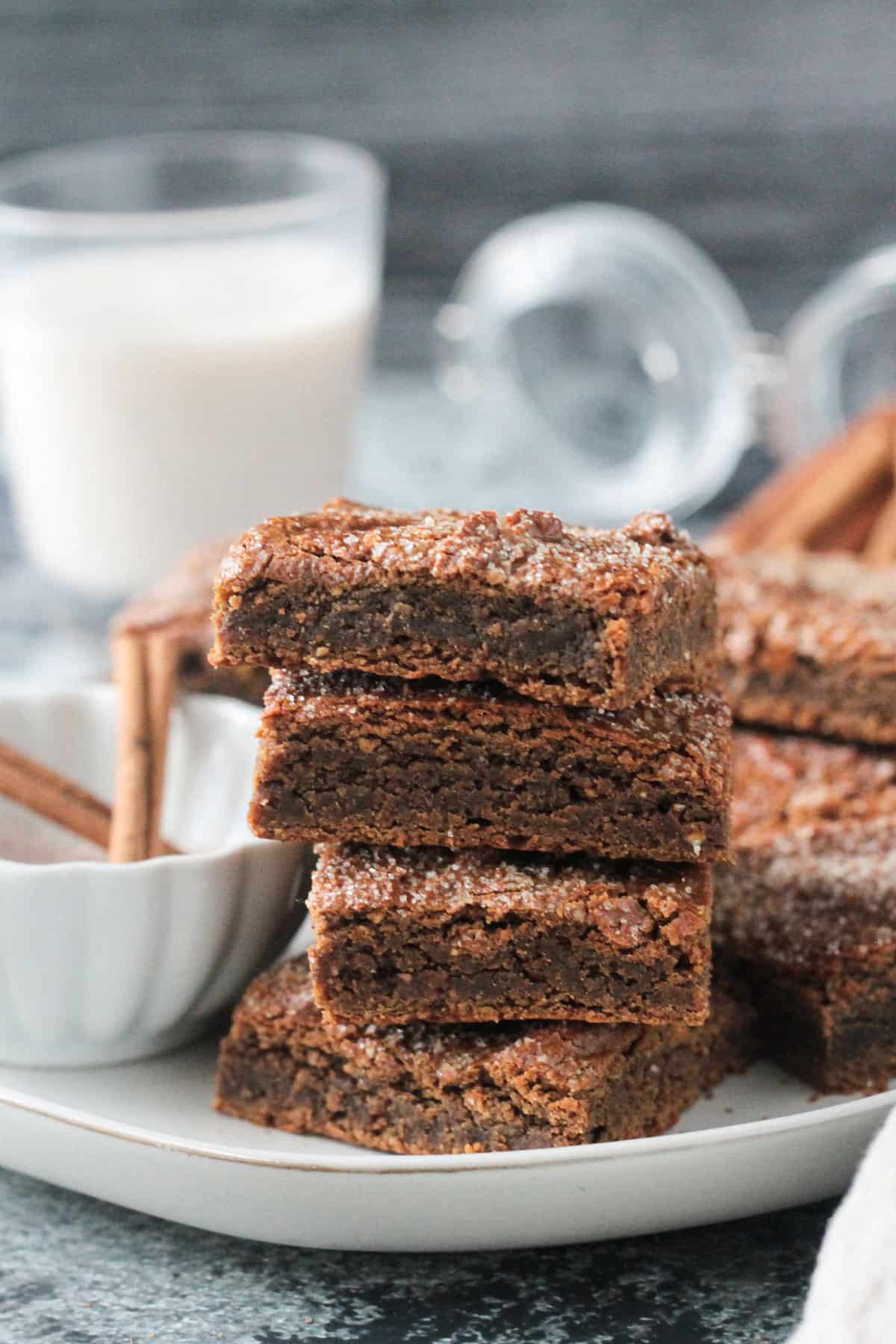 Stack of 4 cinnamon chickpea blondies on a plate.