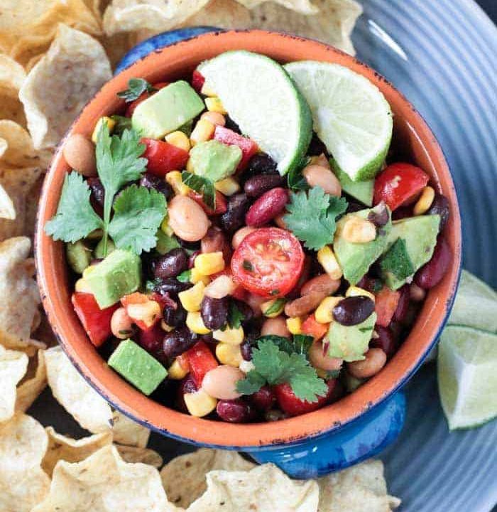 bean dip on a plate with tortilla chips