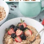 Bowl of oatmeal and berries with a spoon.