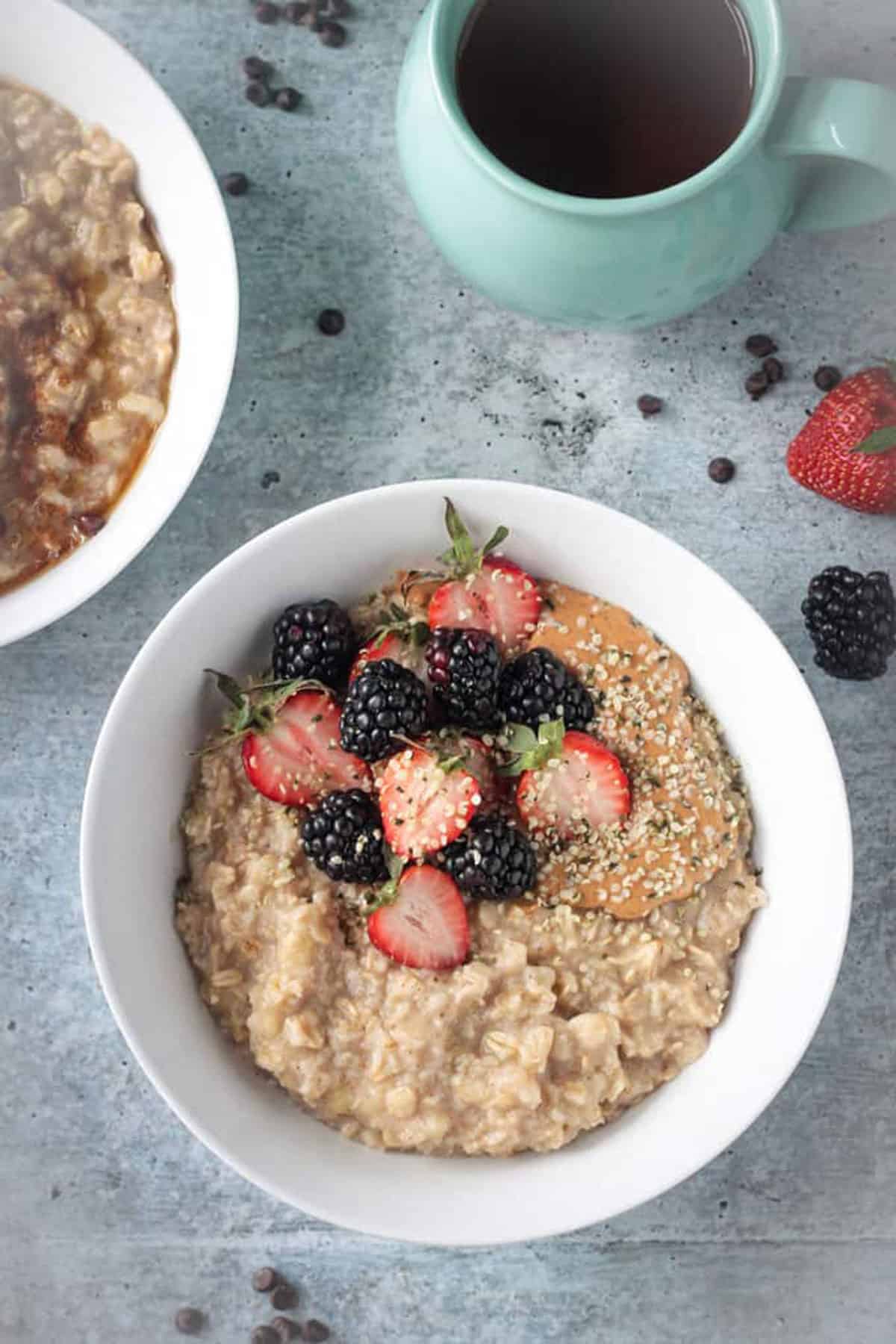 Overhead view of healthy oatmeal topped with berries and hemp seeds.