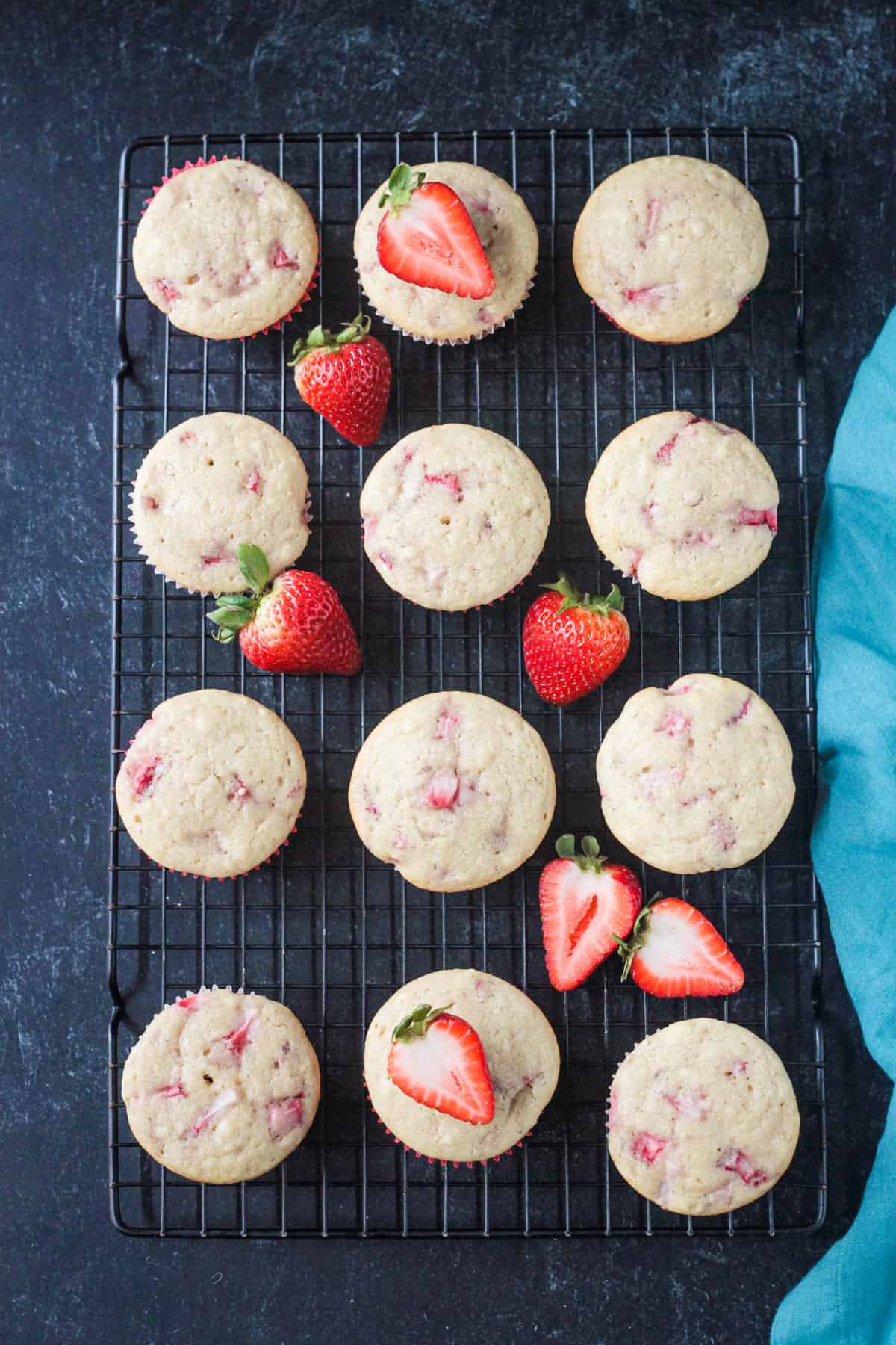 Baked strawberry cupcakes on a cooling rack.