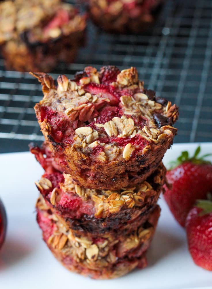 Stack of three Strawberry Banana Baked Oatmeal muffins.
