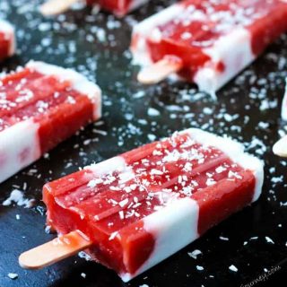 red and white popsicles on a black tray