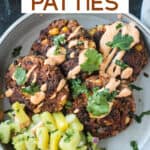 Four black bean patties on a plate with pineapple avocado salsa and chipotle crema.