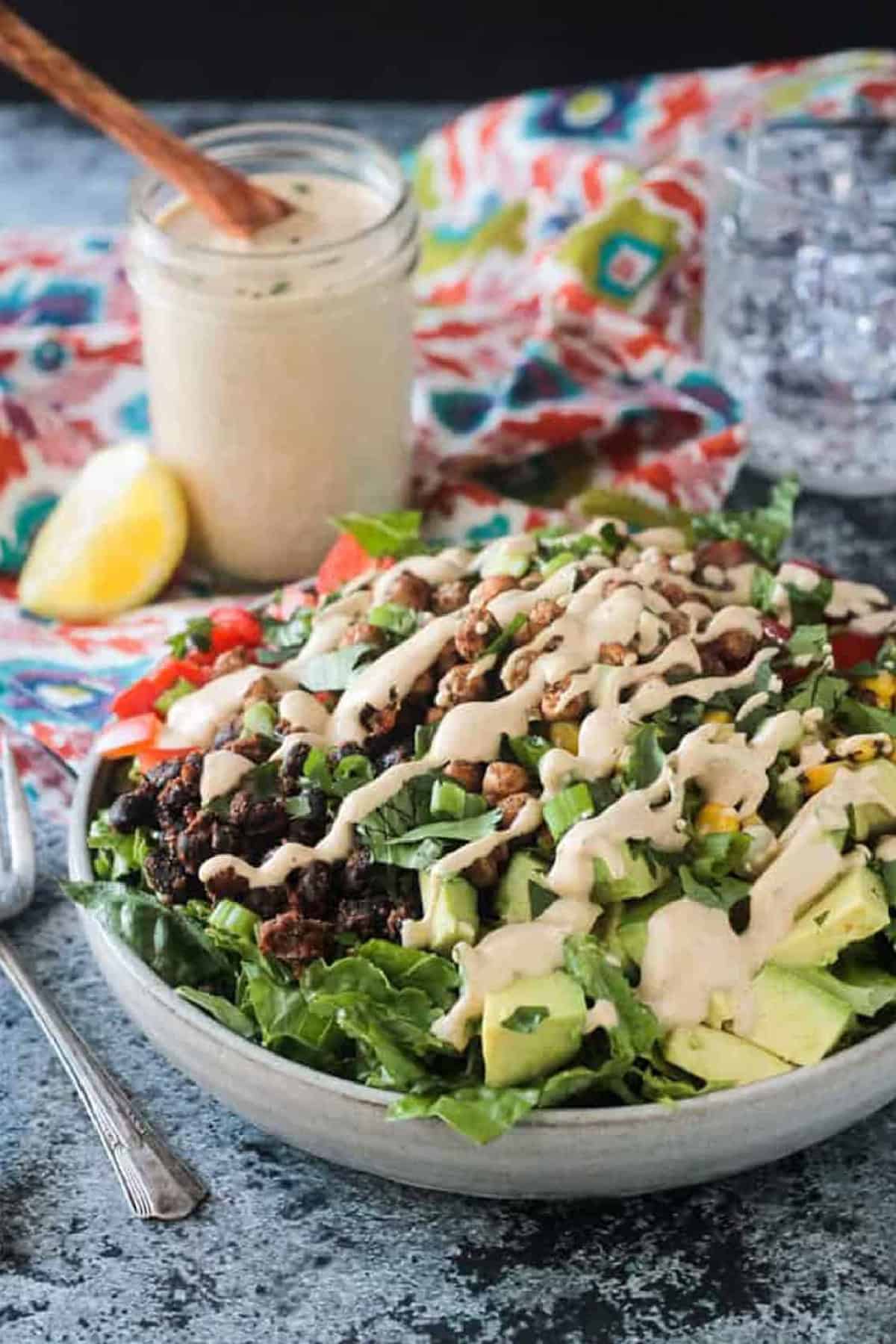 Salad dressing drizzled over the top of a black bean taco salad.