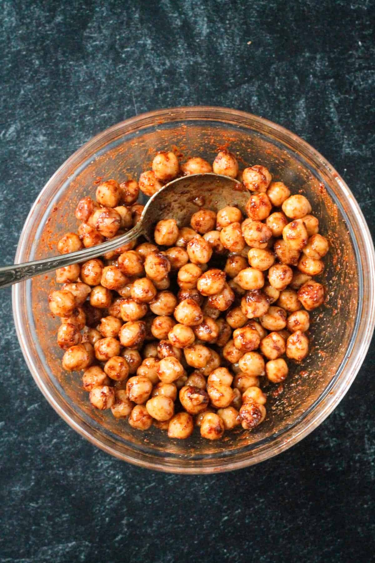 Chickpeas and spices mixed together in a bowl.