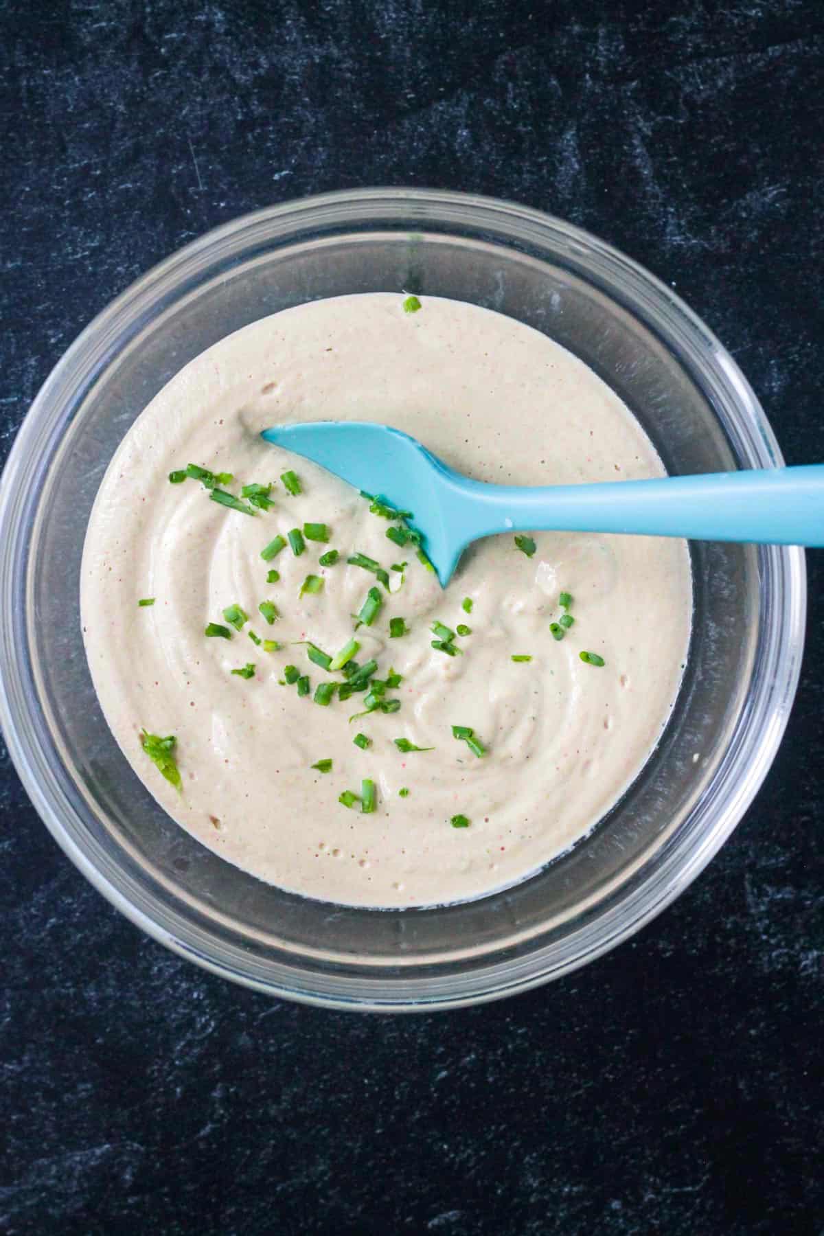 Finished recipe in a bowl with a small blue spatula.