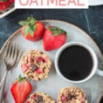 Three strawberry baked oatmeal muffins on a plate with a cup of coffee and fresh strawberries.