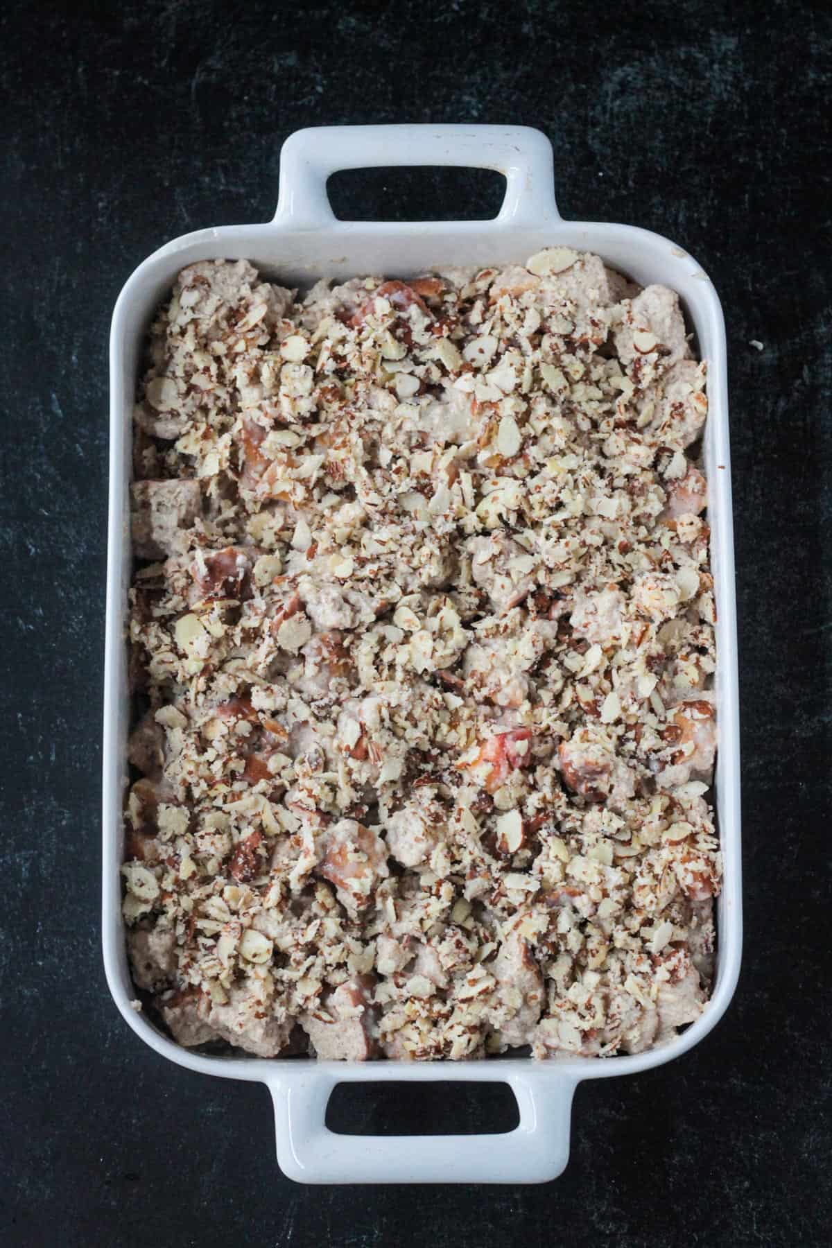 Unbaked casserole with an almond streusel topping.