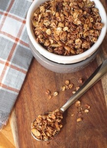 spoonful of granola in front of a bowl