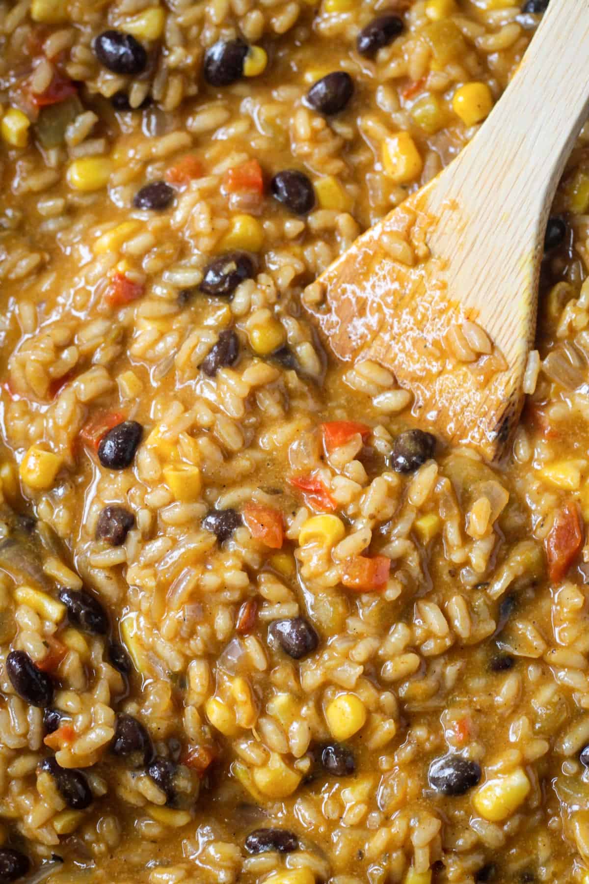 Close up of the creamy texture of risotto with black beans, corn, and peppers.