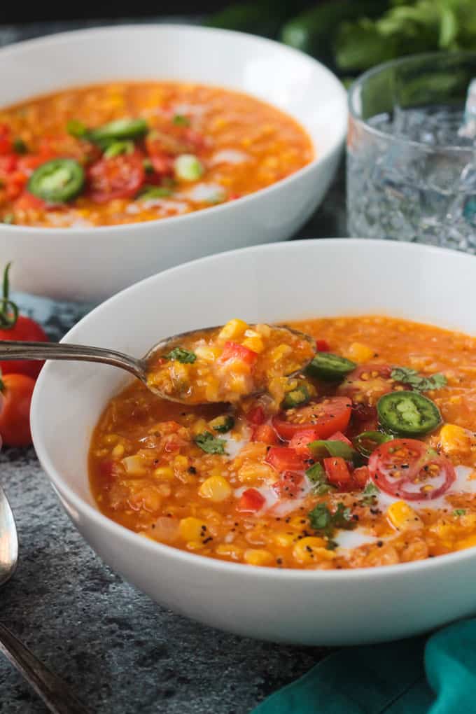 Spoonful of soup being lifted out of a bowl.