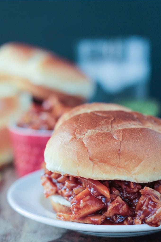 BBQ Jackfruit Sandwich on a bun on a white plate.