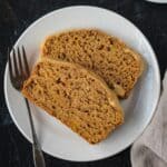 Two slices of butternut squash bread on a white plate.