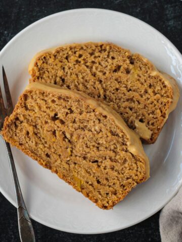 Two slices of butternut squash bread on a white plate.