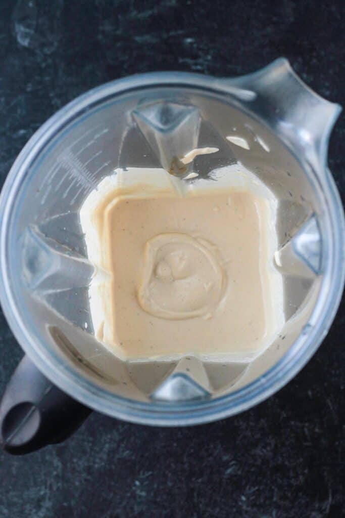 Creamy dip blended in a blender.